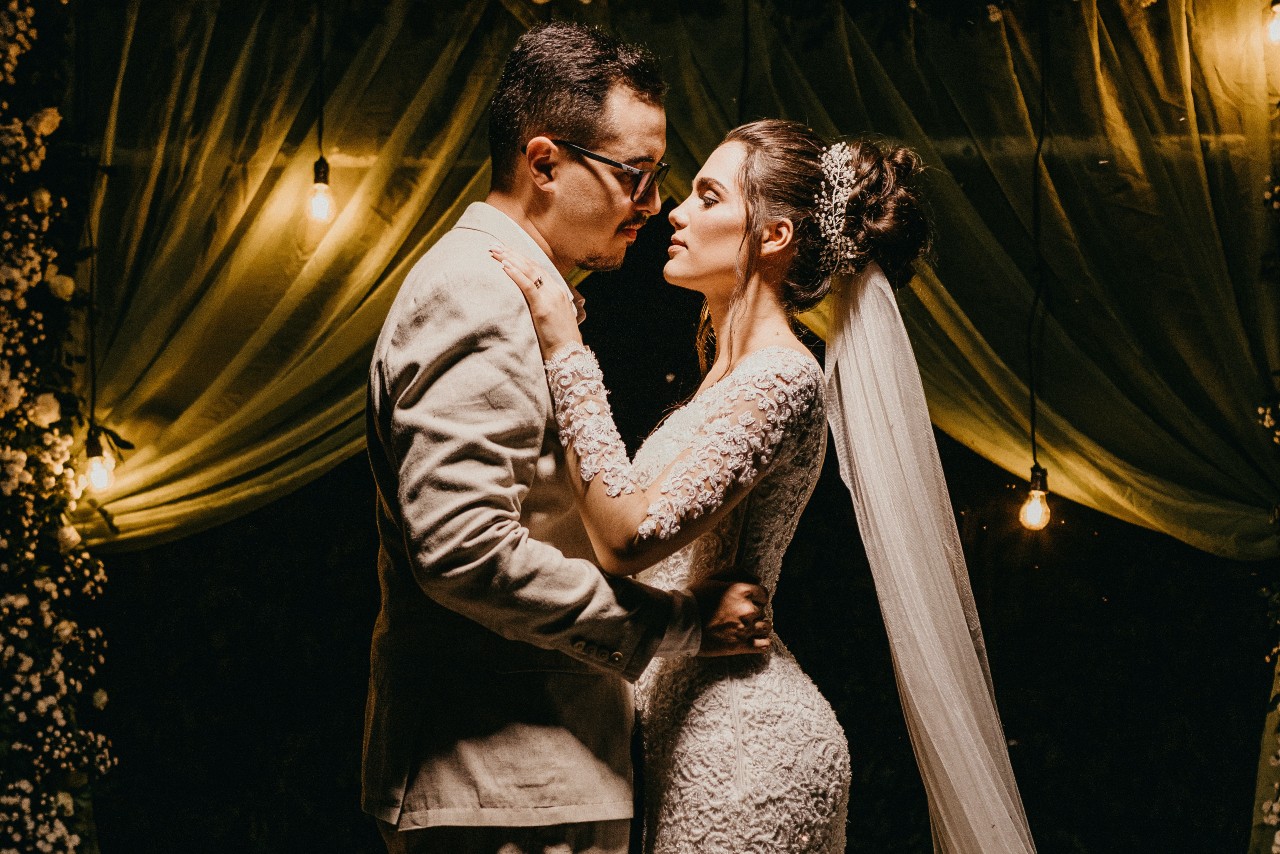 a man and woman embracing in wedding attire