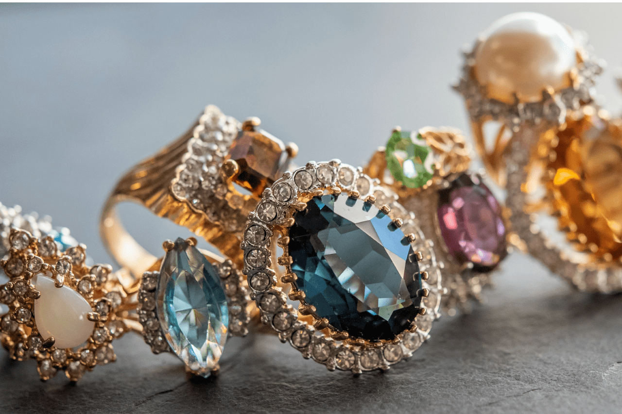 Many different gemstone rings with diamond and yellow gold details