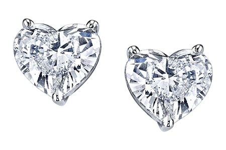 A white gold pair of diamond studs that feature heart-shaped diamonds