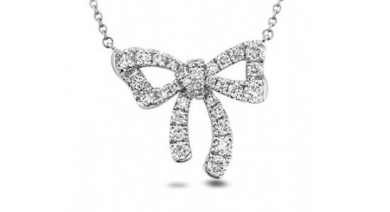 A white gold Memoire bow pendant necklace with diamond accents, available at Weston Jewelers.