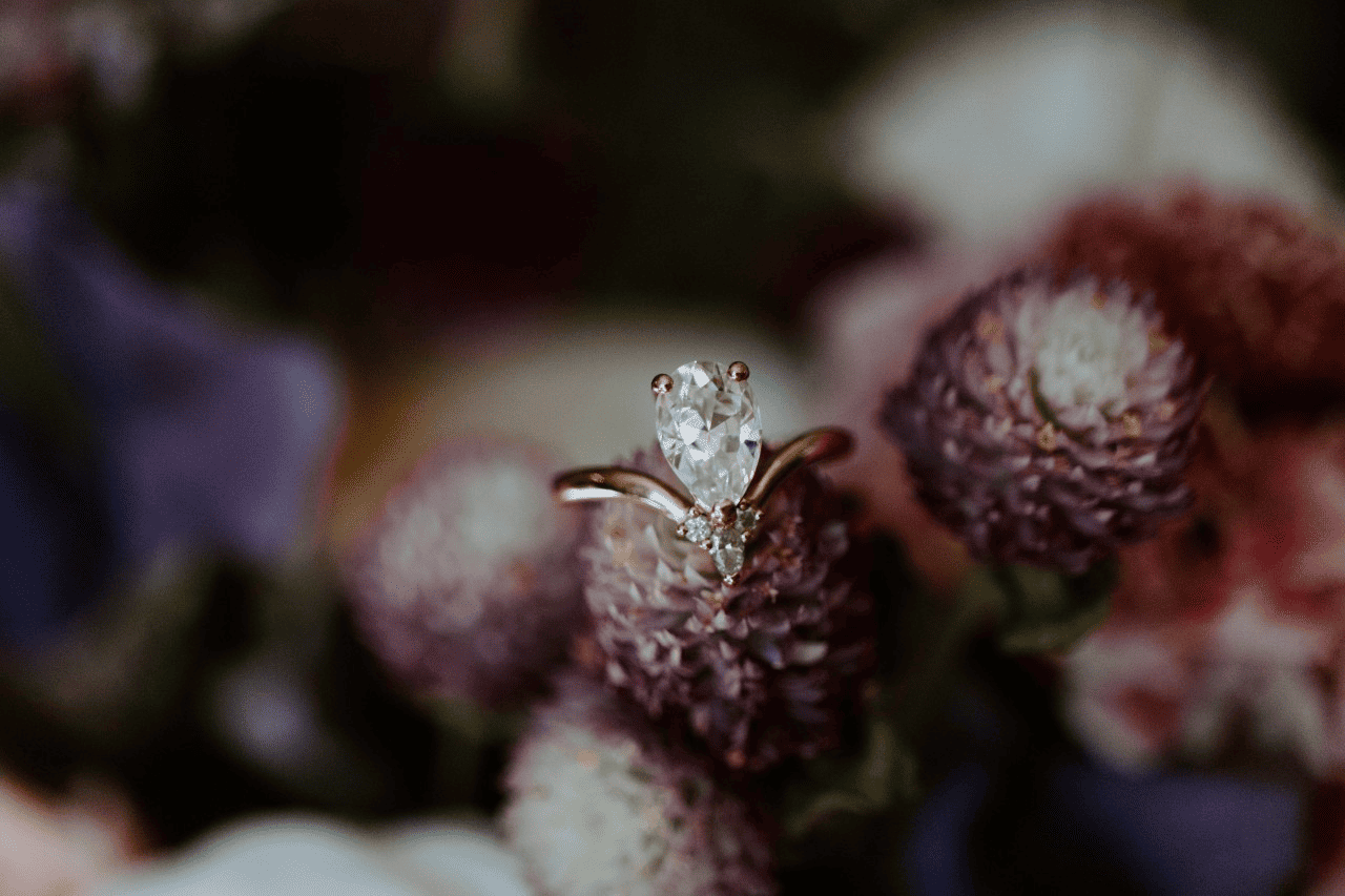 diamond engagement ring in a floral background.