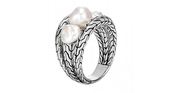a sterling silver ring featuring textured detail and three pearls