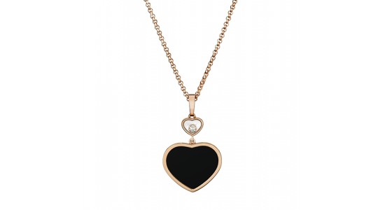 a rose gold necklace featuring two heart motif pendants, one filled with black