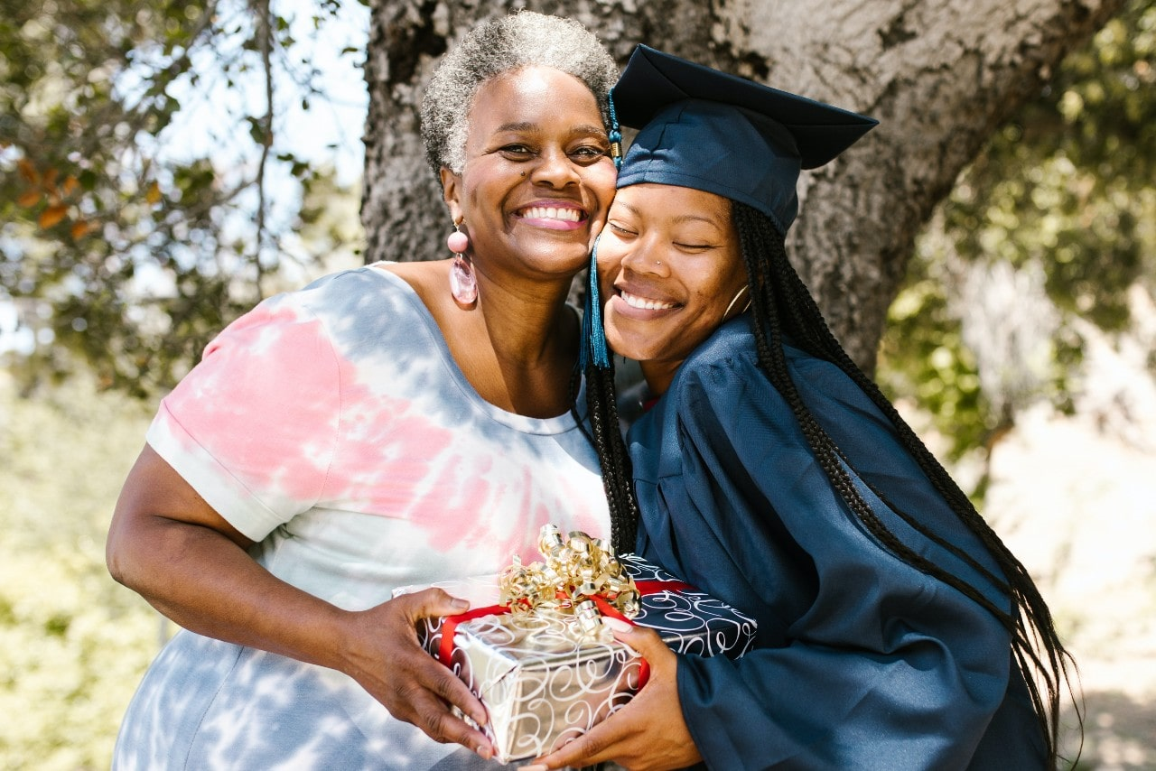 a mother and daughter celebrating with matching jewelry