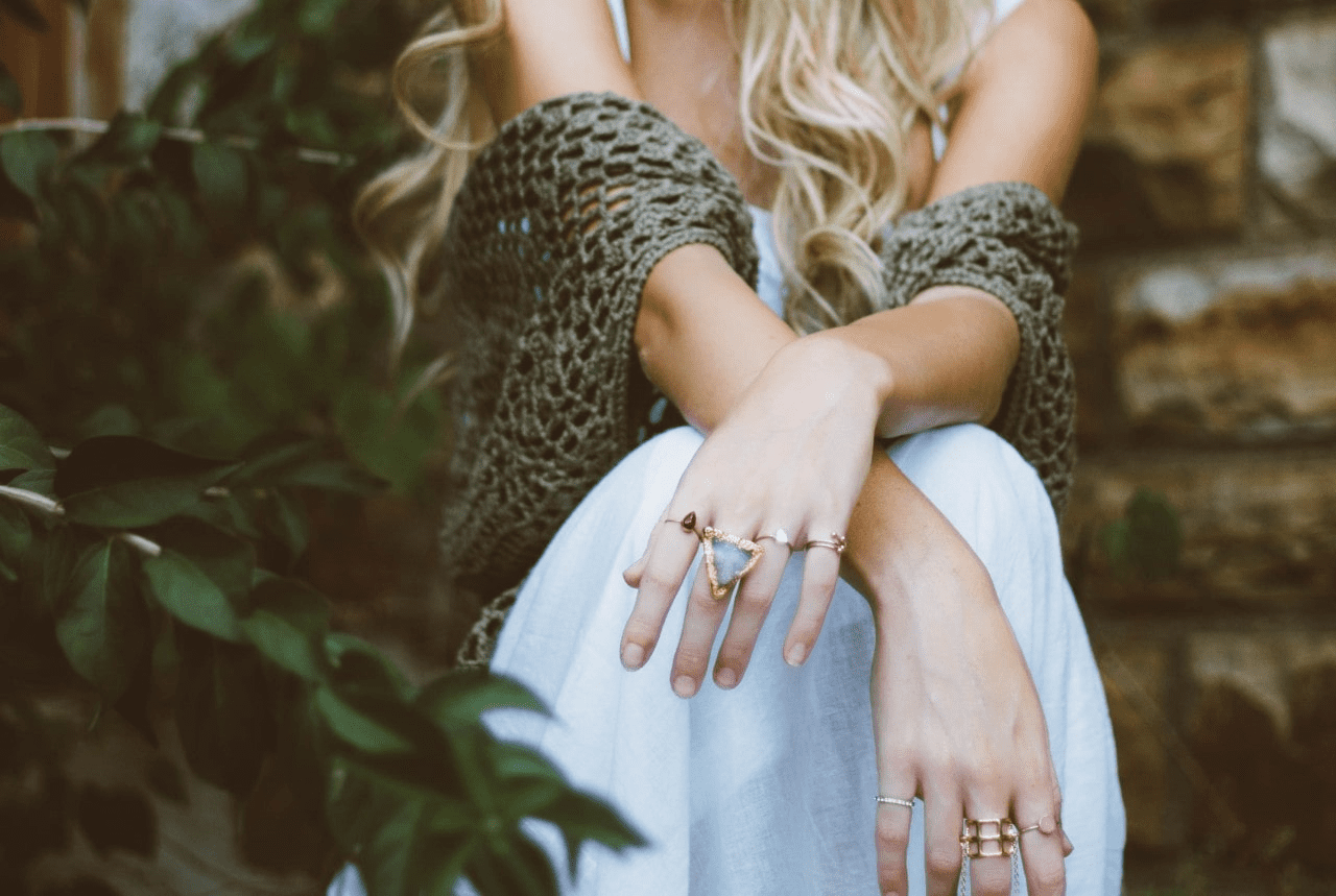 lady wearing stylish clothing and layered fashion rings