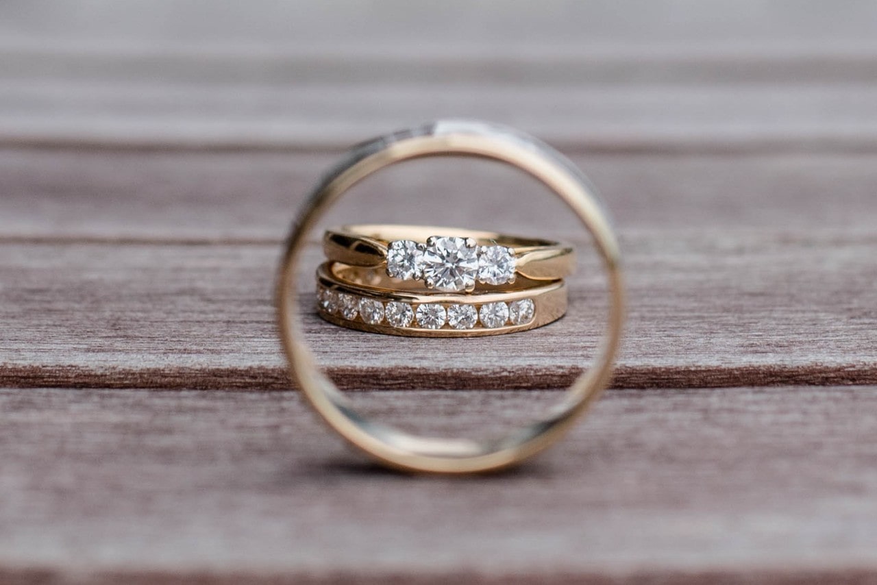 Two diamond wedding bands on a table.