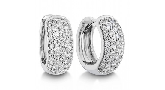 a white gold pair of huggie earrings with pave set diamonds