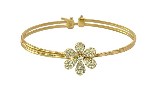 a yellow gold bangle bracelet featuring a diamond studded heart motif