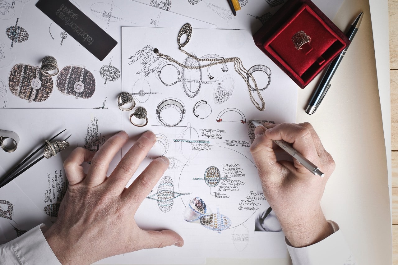 An overhead view of a jeweler creating a custom design.
