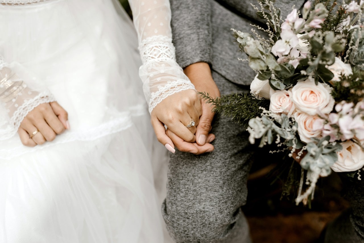 a bride and groom holding hands on their wedding day
