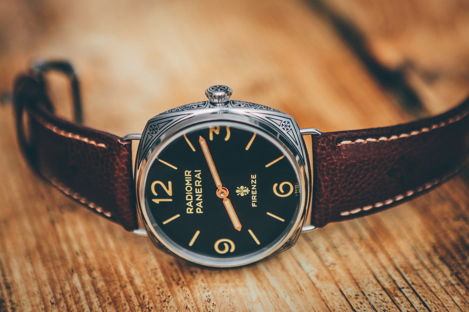A close-up of a wristwatch with a cushion-shaped case.