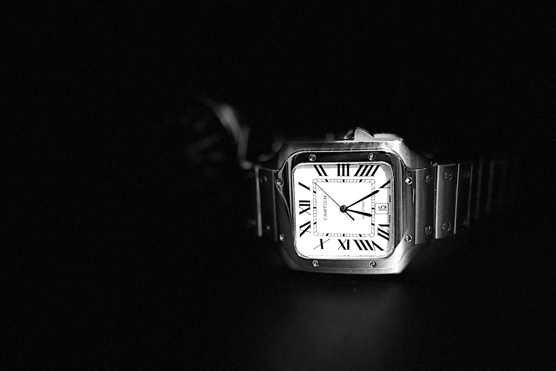 a Cartier timepiece on a black background