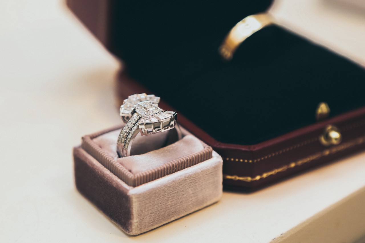 An Art Deco-inspired engagement ring sits in a pink box. An Art Deco-inspired engagement ring sits in a pink box.